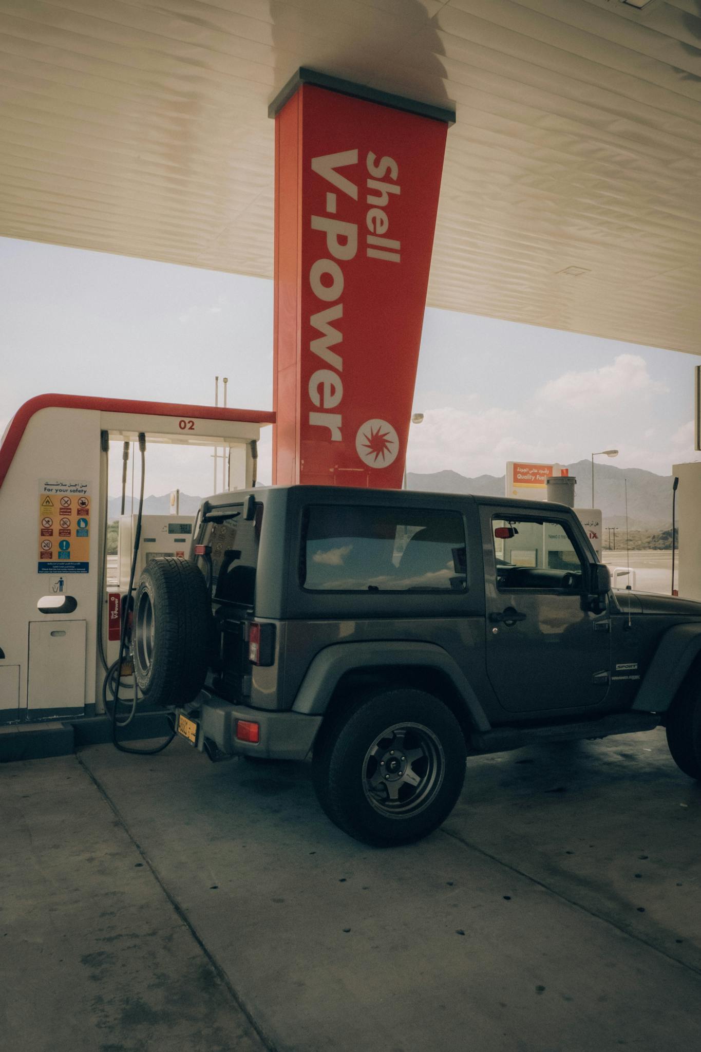 Jeep Wrangler refueling at Shell V-Power in Hatta, Dubai under clear skies.